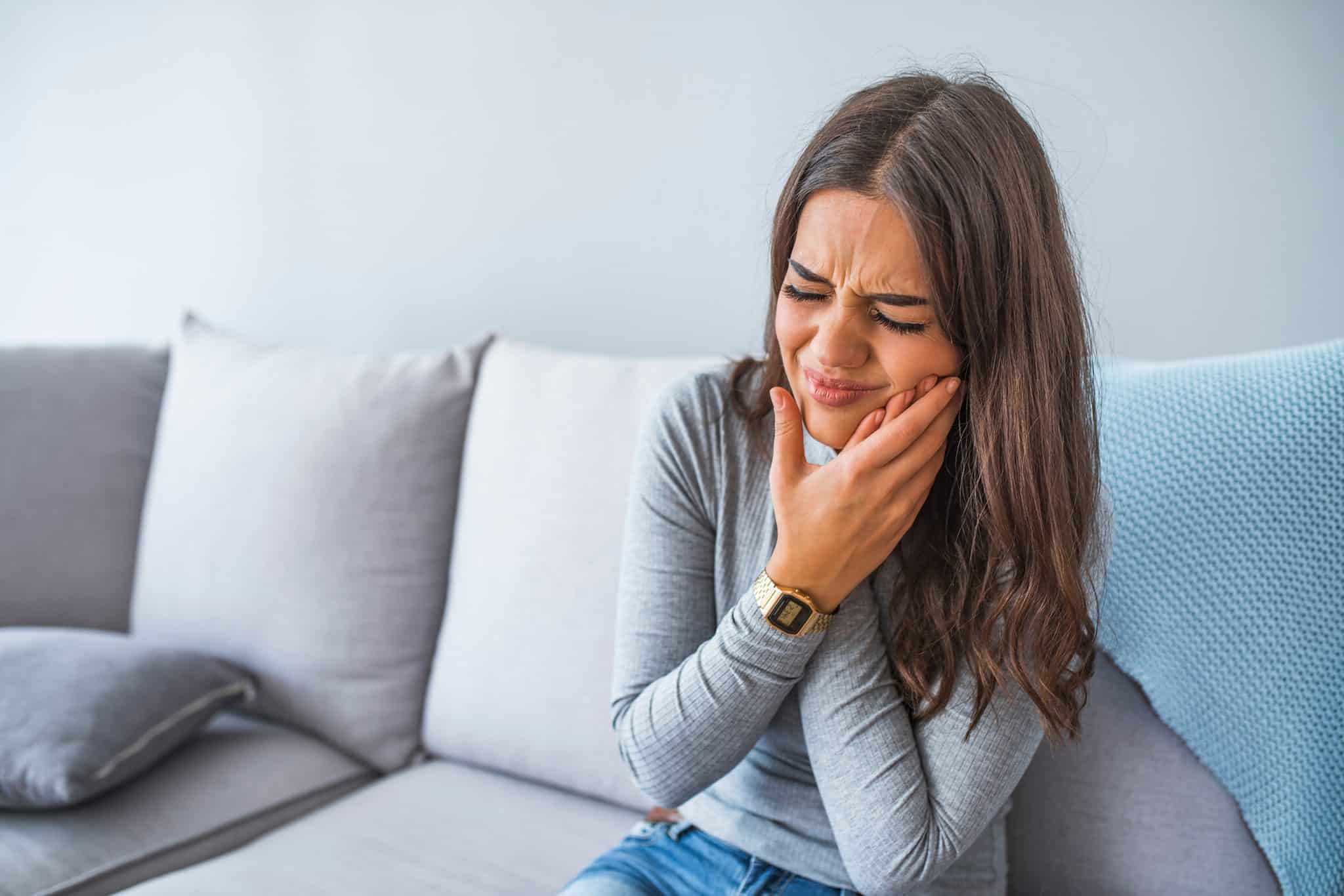 A picture of a woman suffering from a tooth infection.