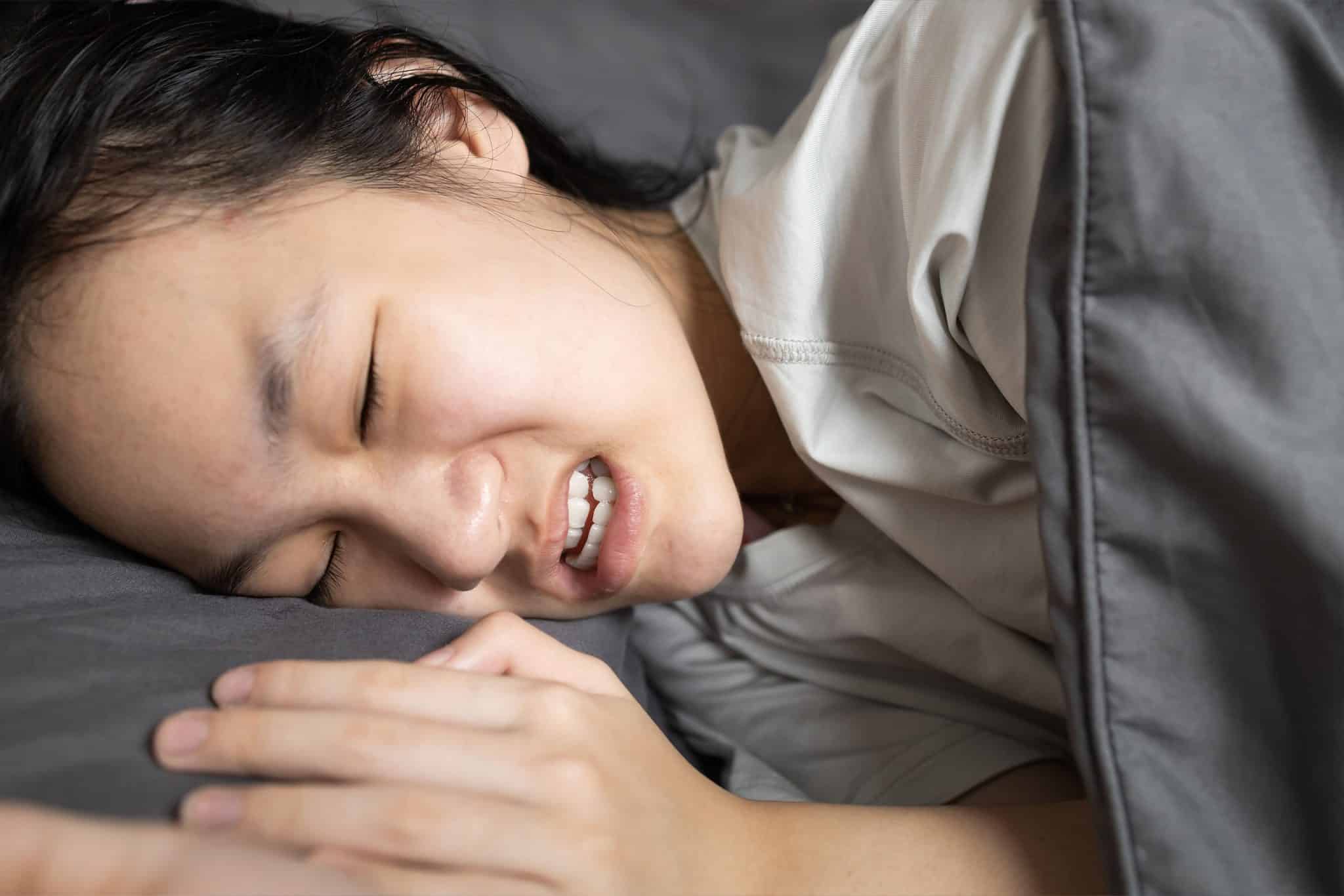young woman grinding her teeth during sleep