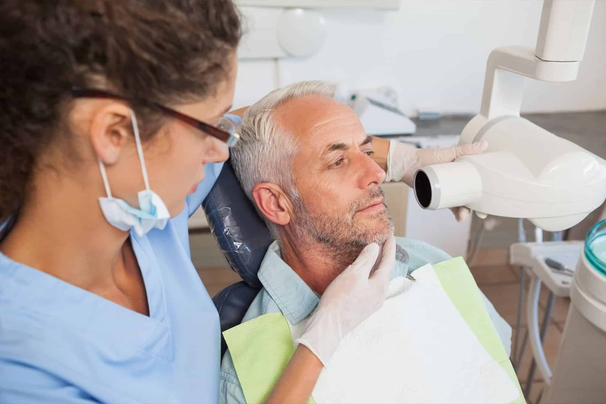 A man getting an x-ray at the dental office.