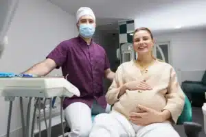 A picture of a pregnant woman during a dental checkup.