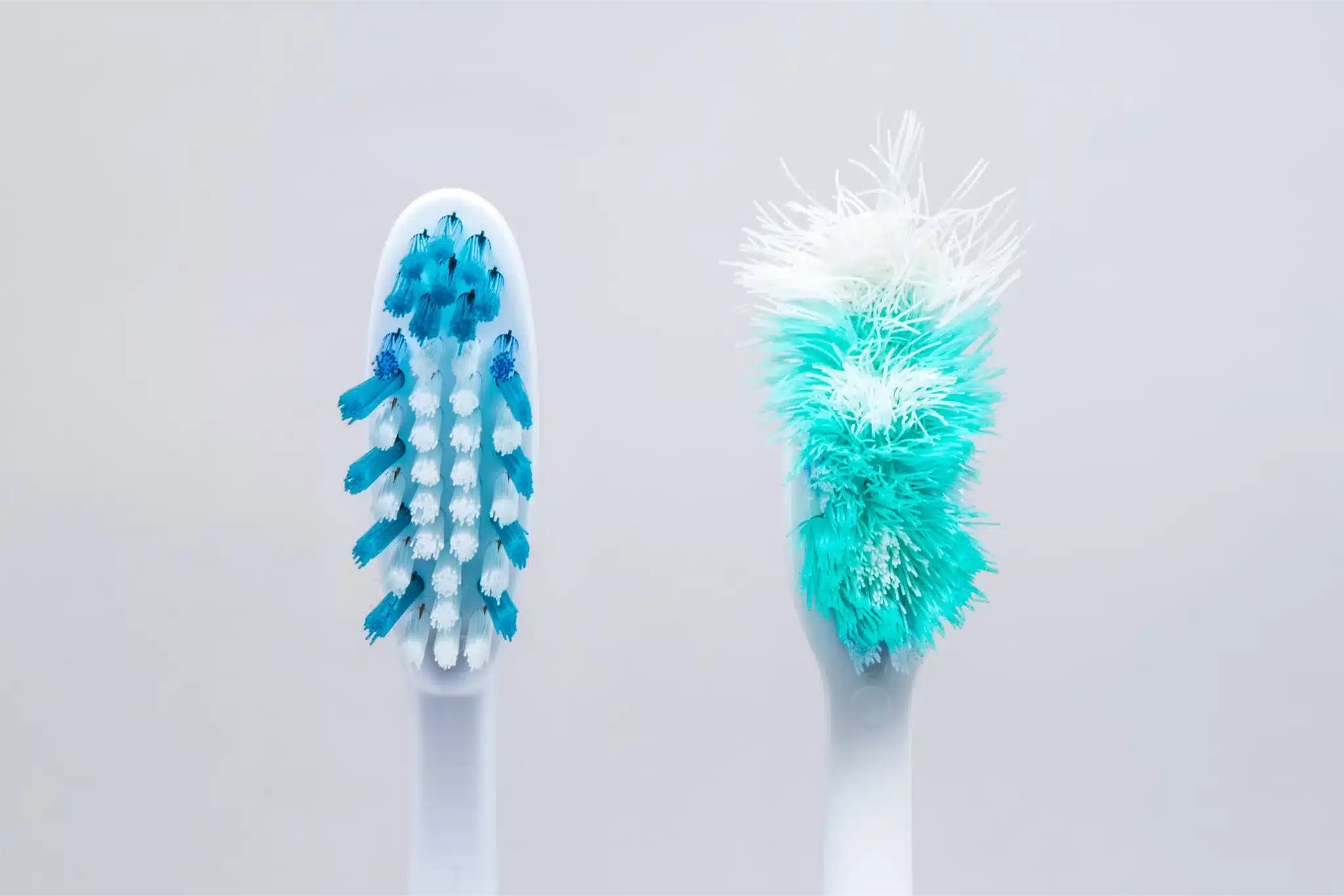 A picture of a new toothbrush and an old toothbrush.